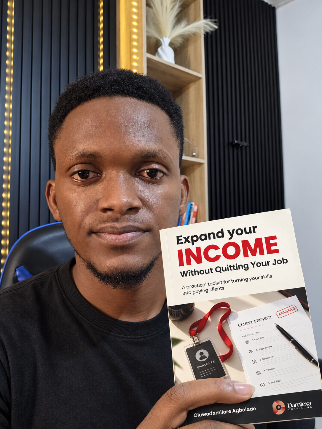 Oluwadamilare Agbolade holding Expand Your Income Without Quitting Your Job